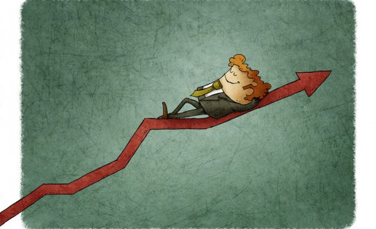 Relaxed smiling businessman lying on a graph going up. Concept of success