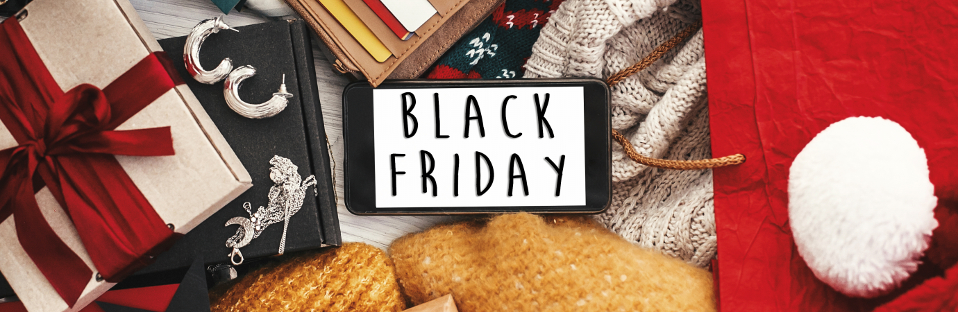 Black Friday big sale text on phone screen, flat lay. Special discount christmas offer. Phone with advertising message at money, wallet, bags, clothes, gift boxes, price tags. Shopping time