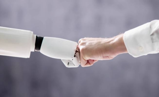 Robot And Human Hand Making Fist Bump On Grey Background