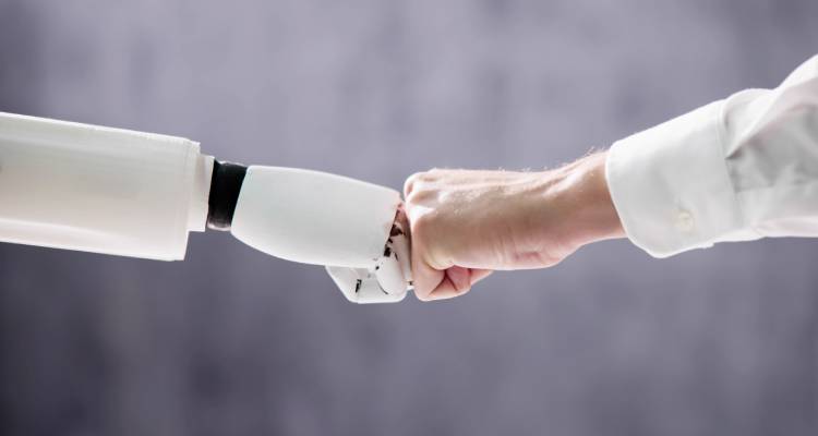 Robot And Human Hand Making Fist Bump On Grey Background